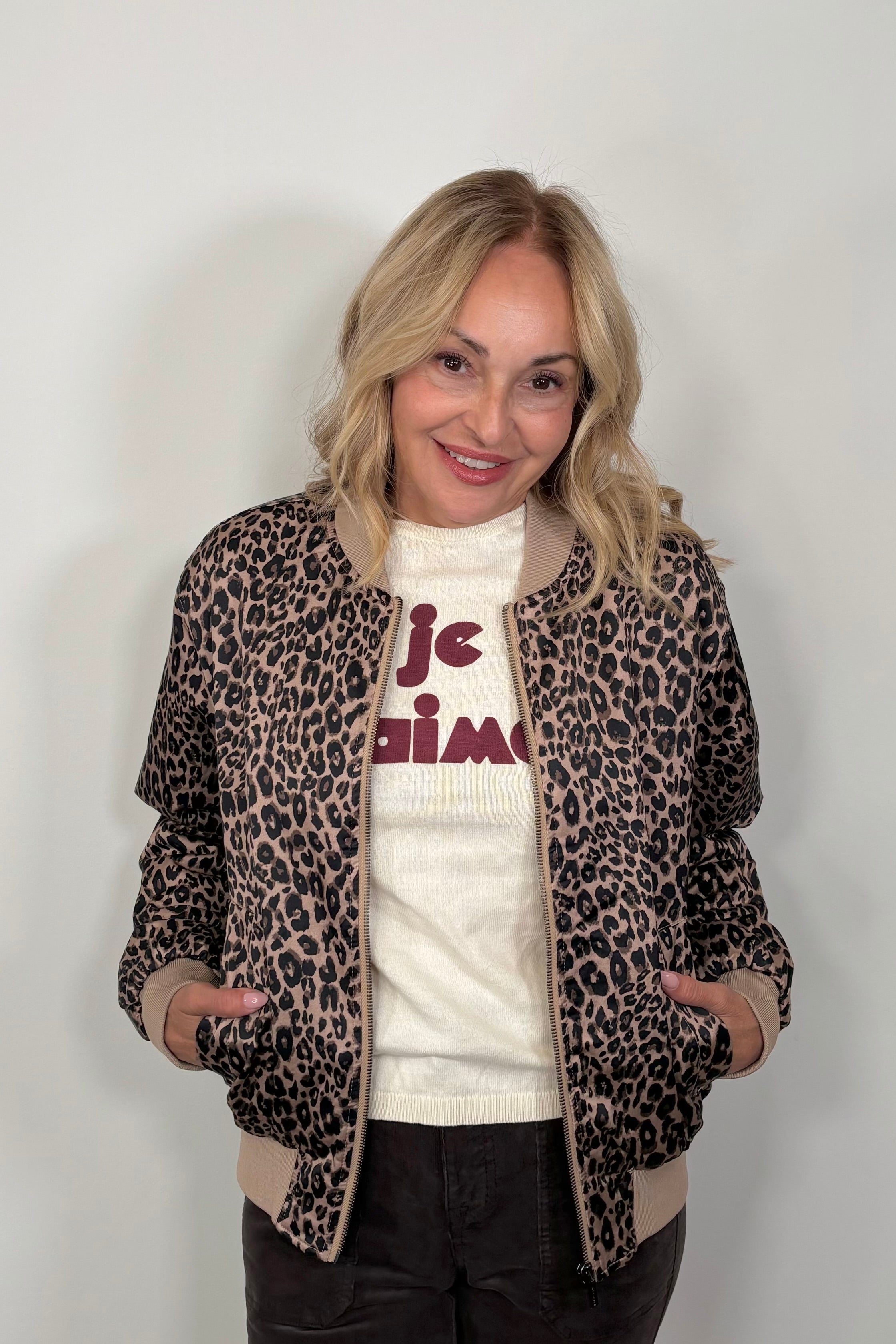 woman wearing a leopard print bomber jacket 