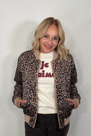 woman wearing a leopard print bomber jacket 