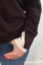 Woman wearing a brown and ivory sweater 
