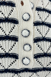 Close up of Woman wearing a black and white striped knitted short sleeve Henley tee