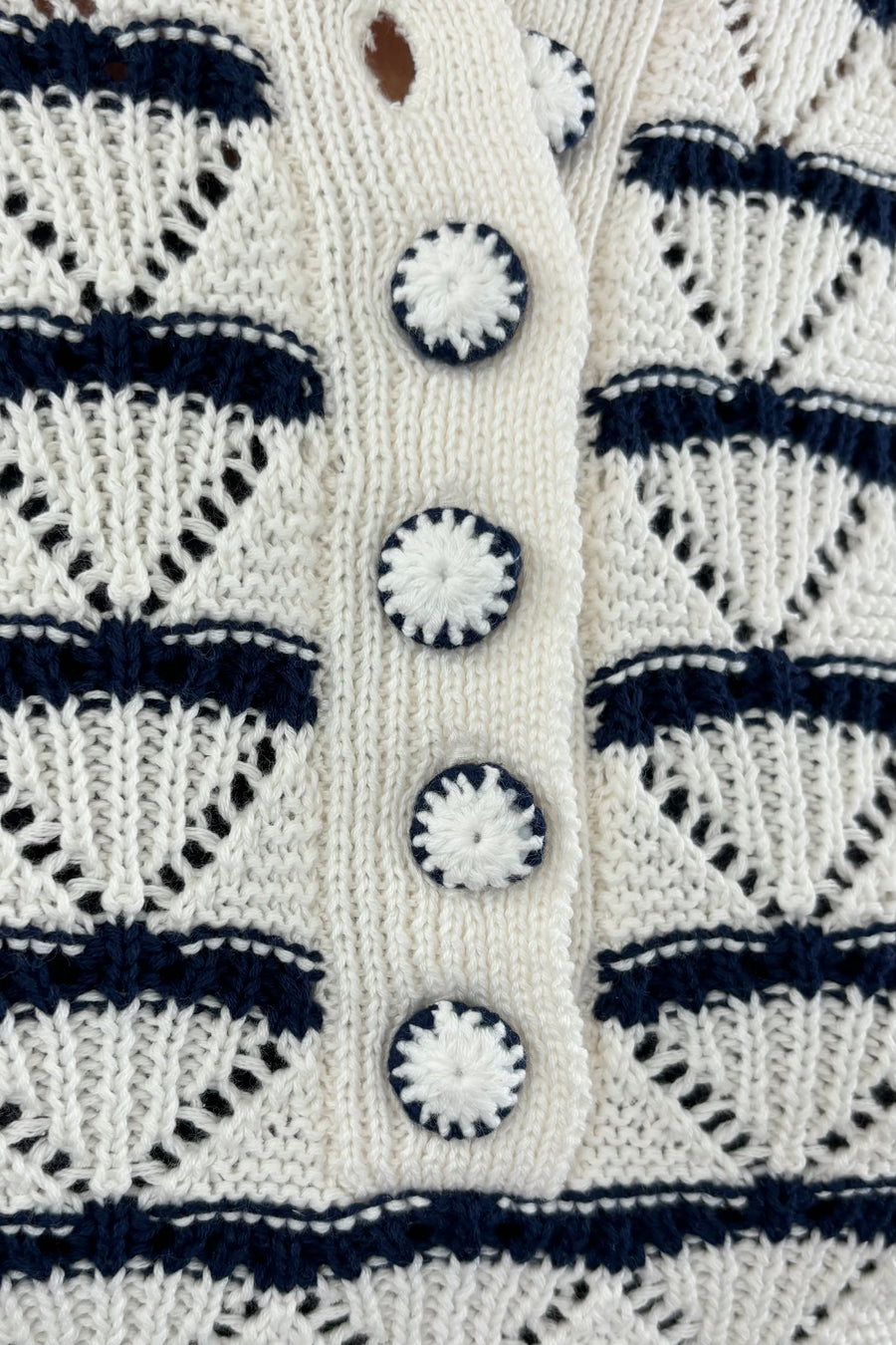 Close up of Woman wearing a black and white striped knitted short sleeve Henley tee