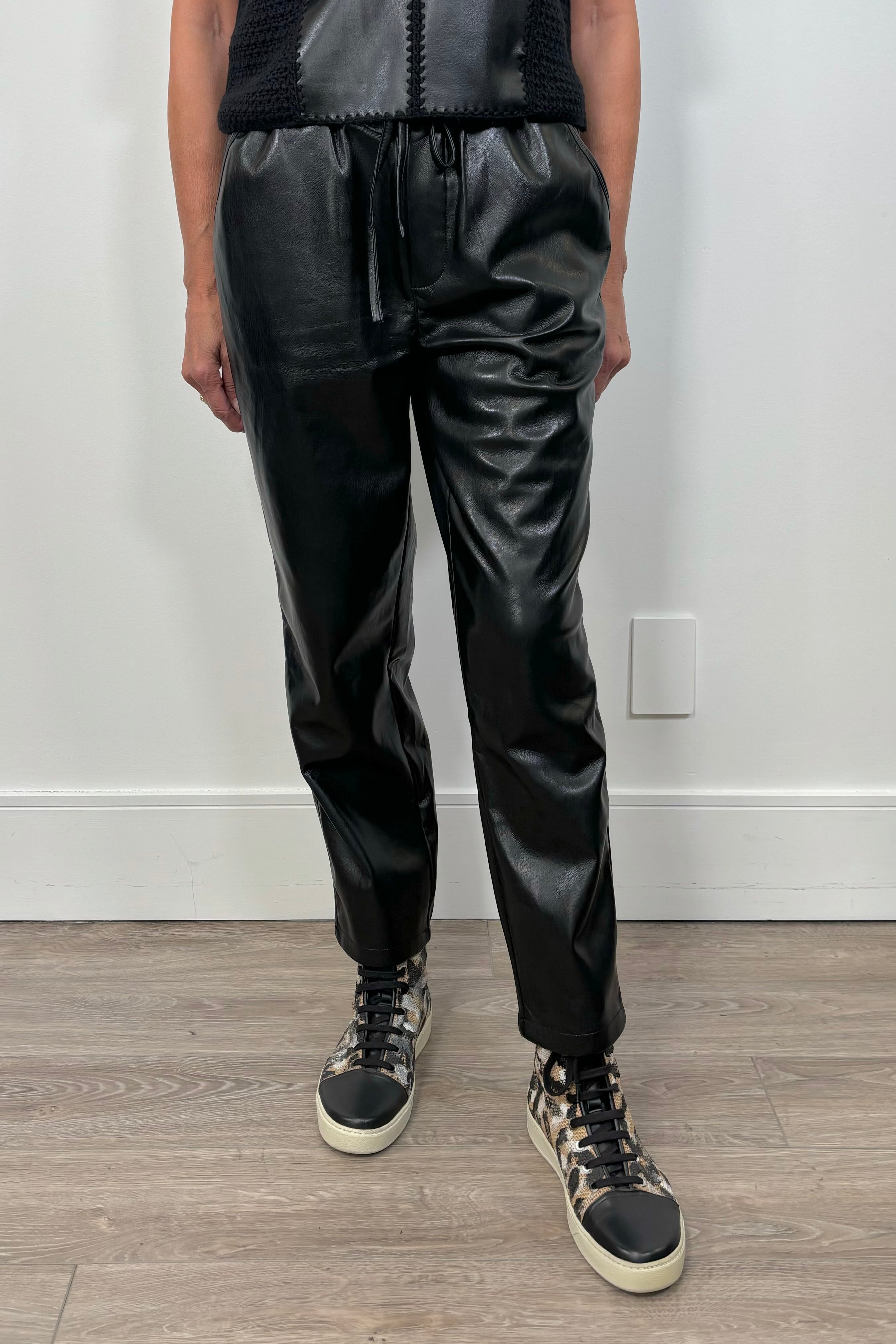 Front view of woman wearing a black drawstring pant