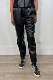Front view of woman wearing a black drawstring pant