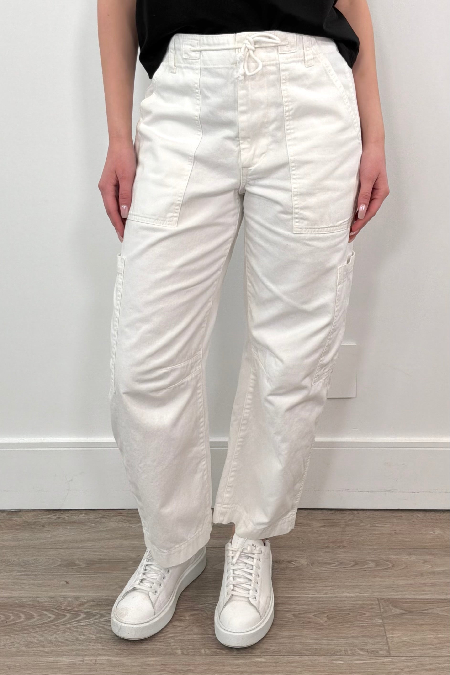 Woman wearing white straight leg cargo pants with string waistband