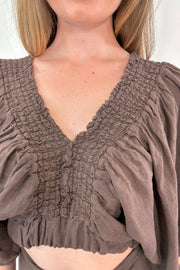 Close-up of women wearing a brown half sleeve blouse linen