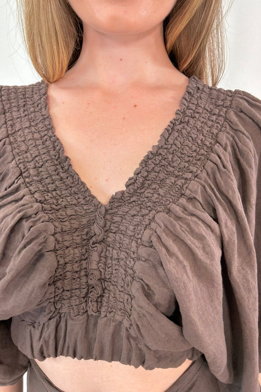 Close-up of women wearing a brown half sleeve blouse linen