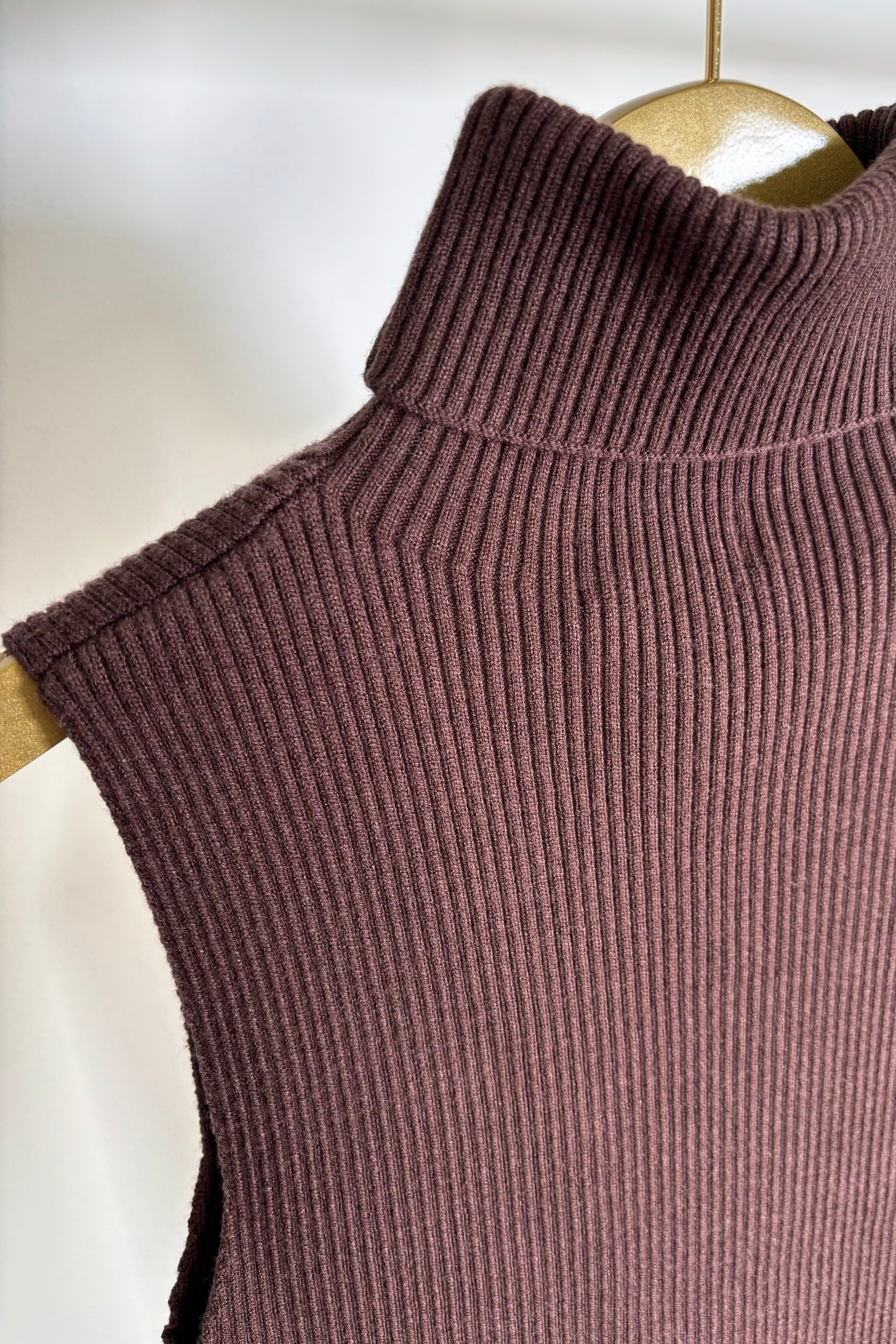 Close up view of a cool brown turtleneck knit tank top