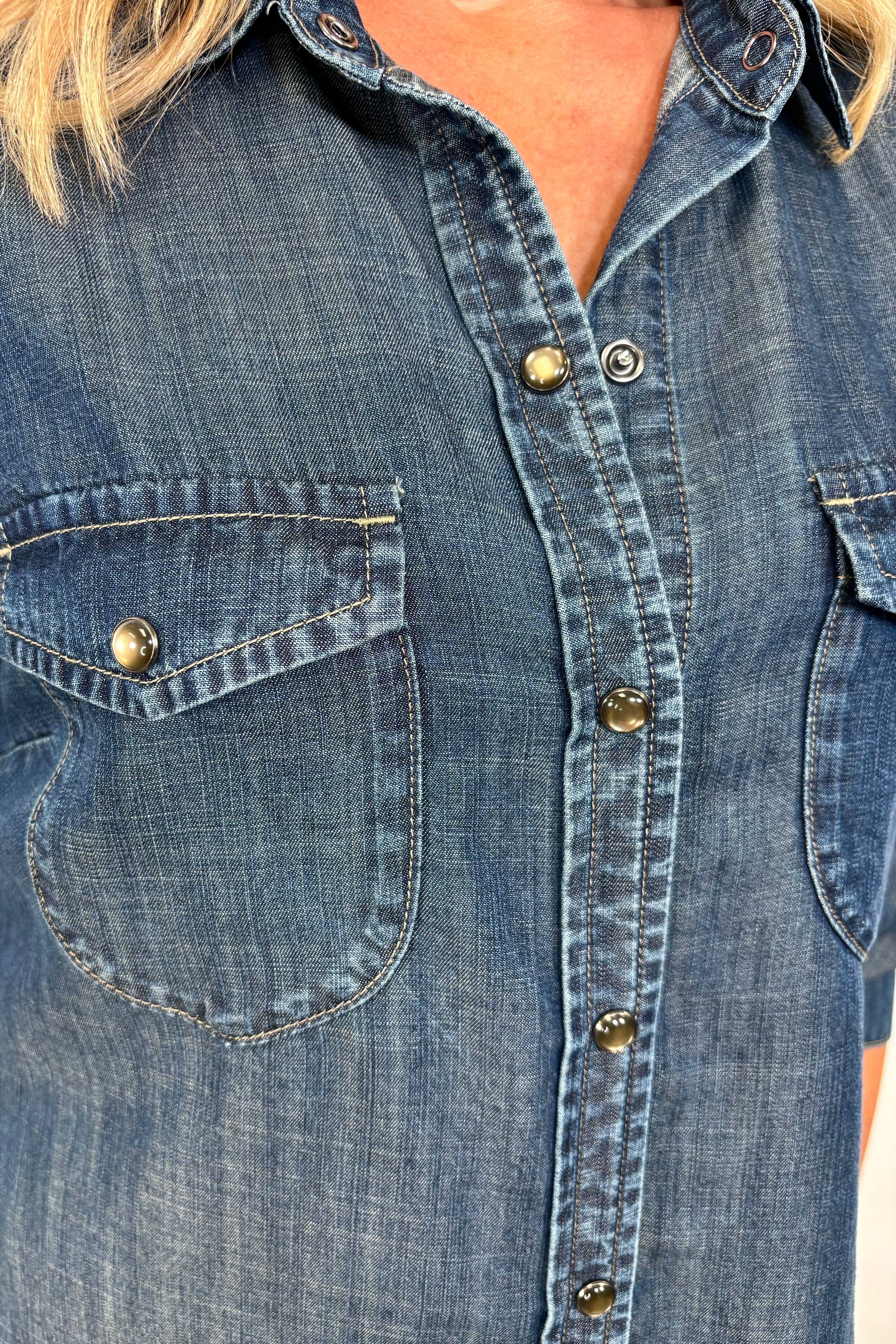 Close-up of woman wearing a western snap blue shirt 