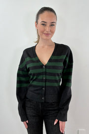 Woman wearing a black and dark green cardigan with black buttons