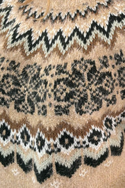 Close-up of a patterned fabric with black, white, and brown colors.