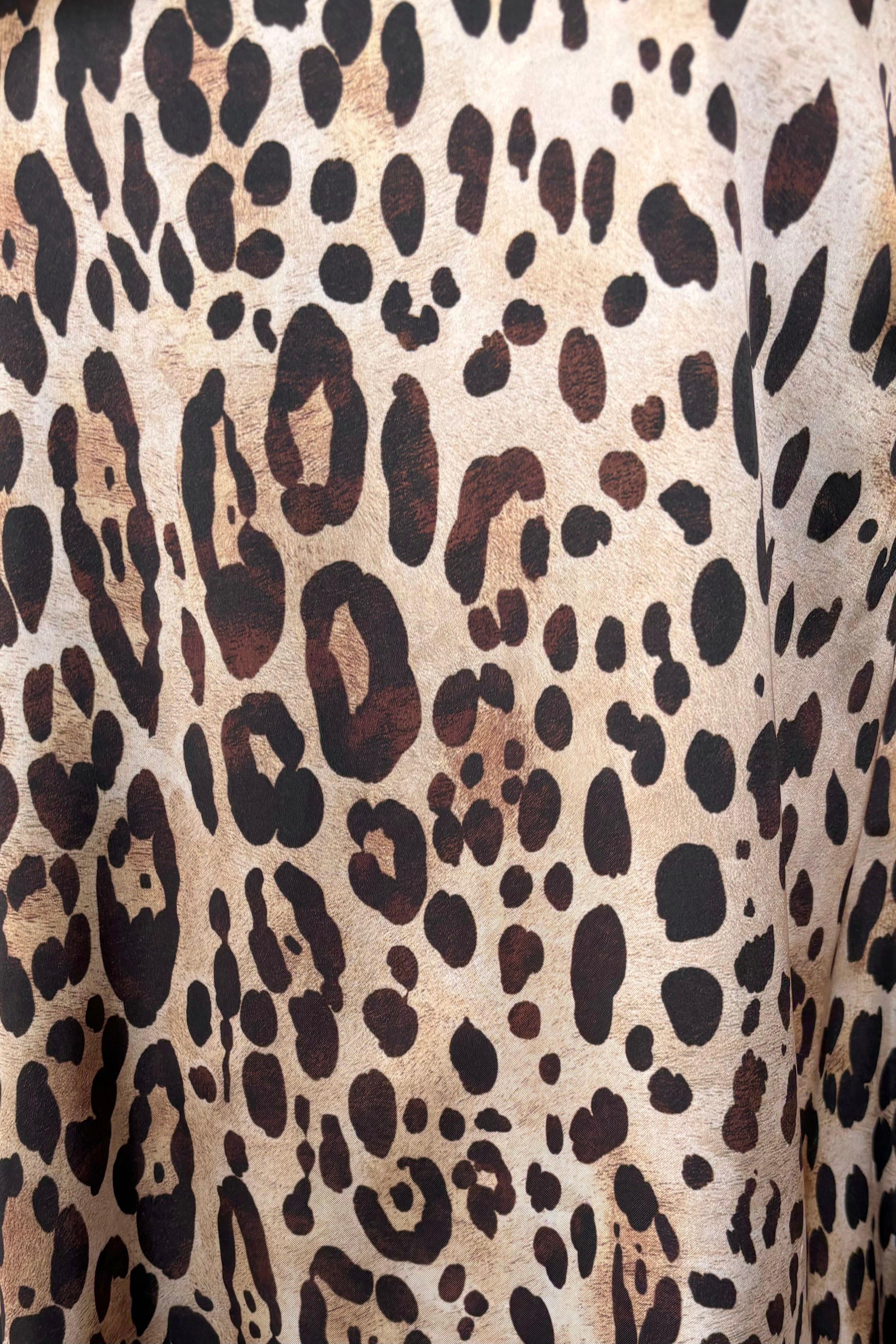 close-up of a 60’s inspired satin leopard print short dress
