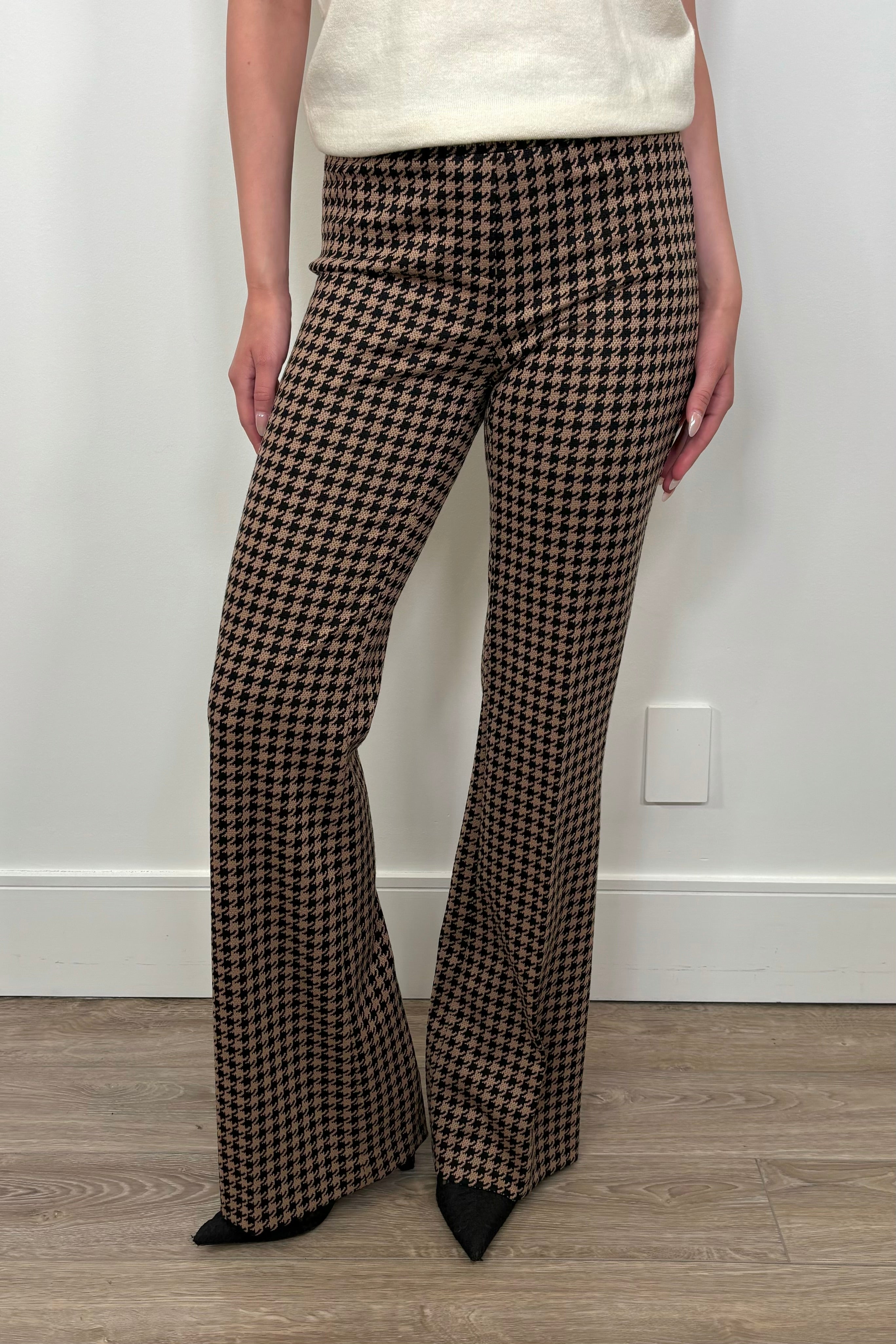 Front view of woman wearing a houndstooth knit pant