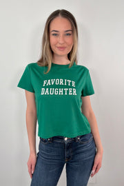 woman wearing a green t-shirt with 'FAVORITE DAUGHTER' text 