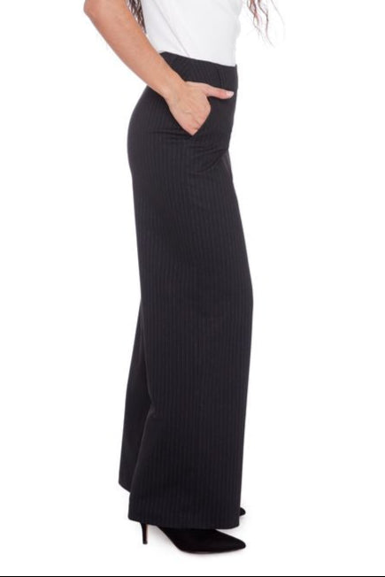 Side view of woman wearing black pinstriped ponte pants