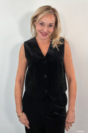 Woman wearing a black velvet vest 