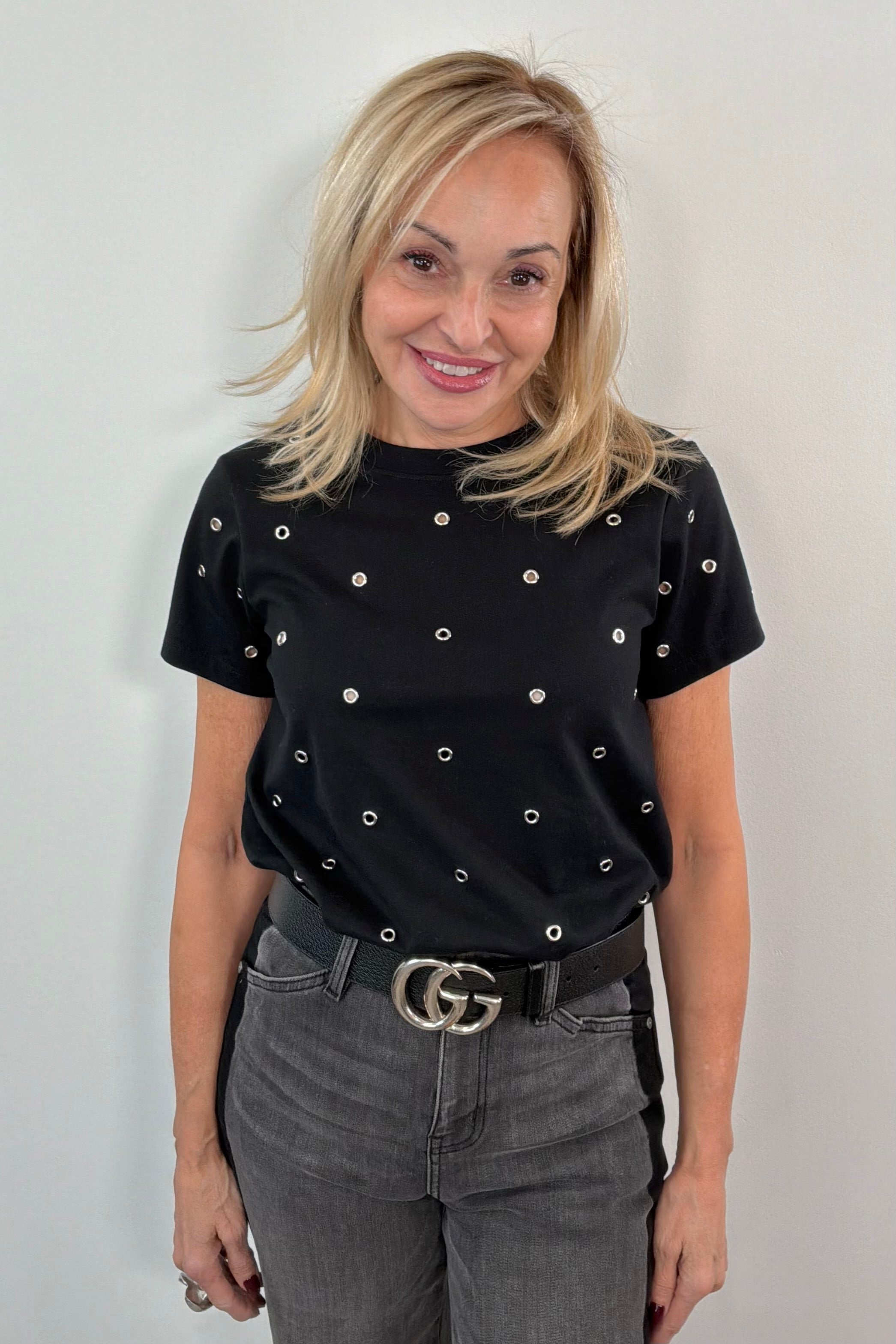 woman wearing a black top with metal embellishments