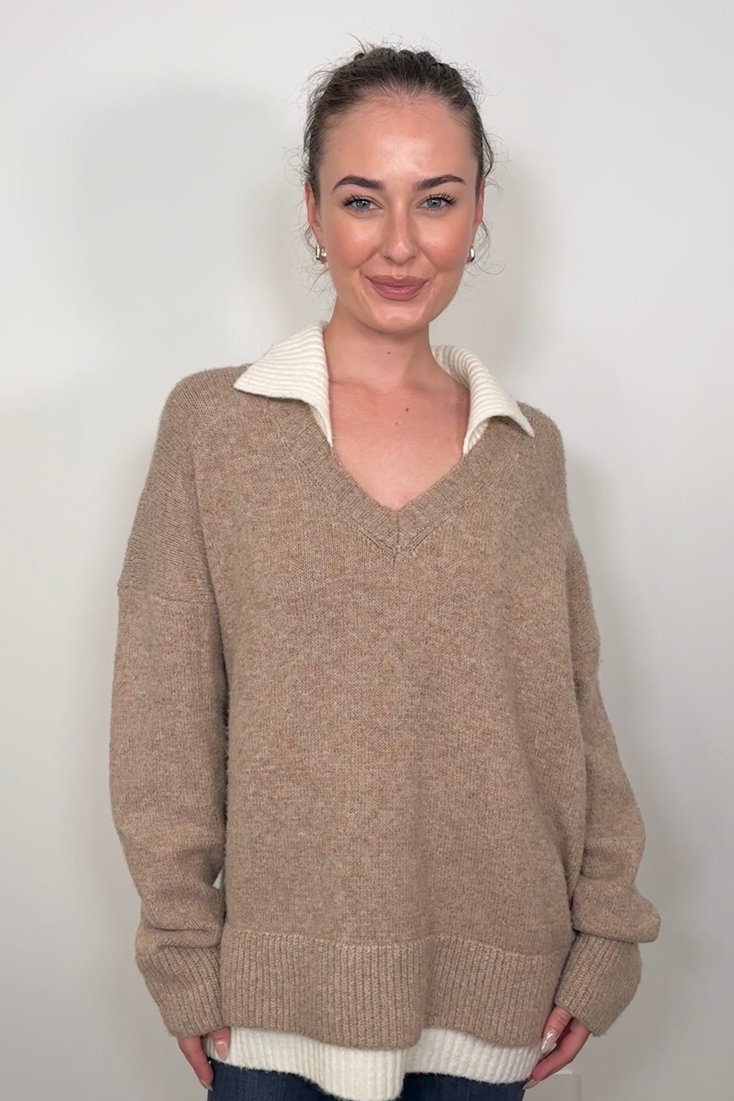 Front view of woman wearing a cool beige white- collar sweater
