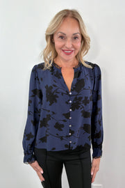 Woman wearing a blue floral blouse 