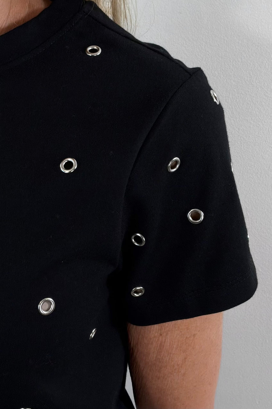 close up of a black top with metal embellishments