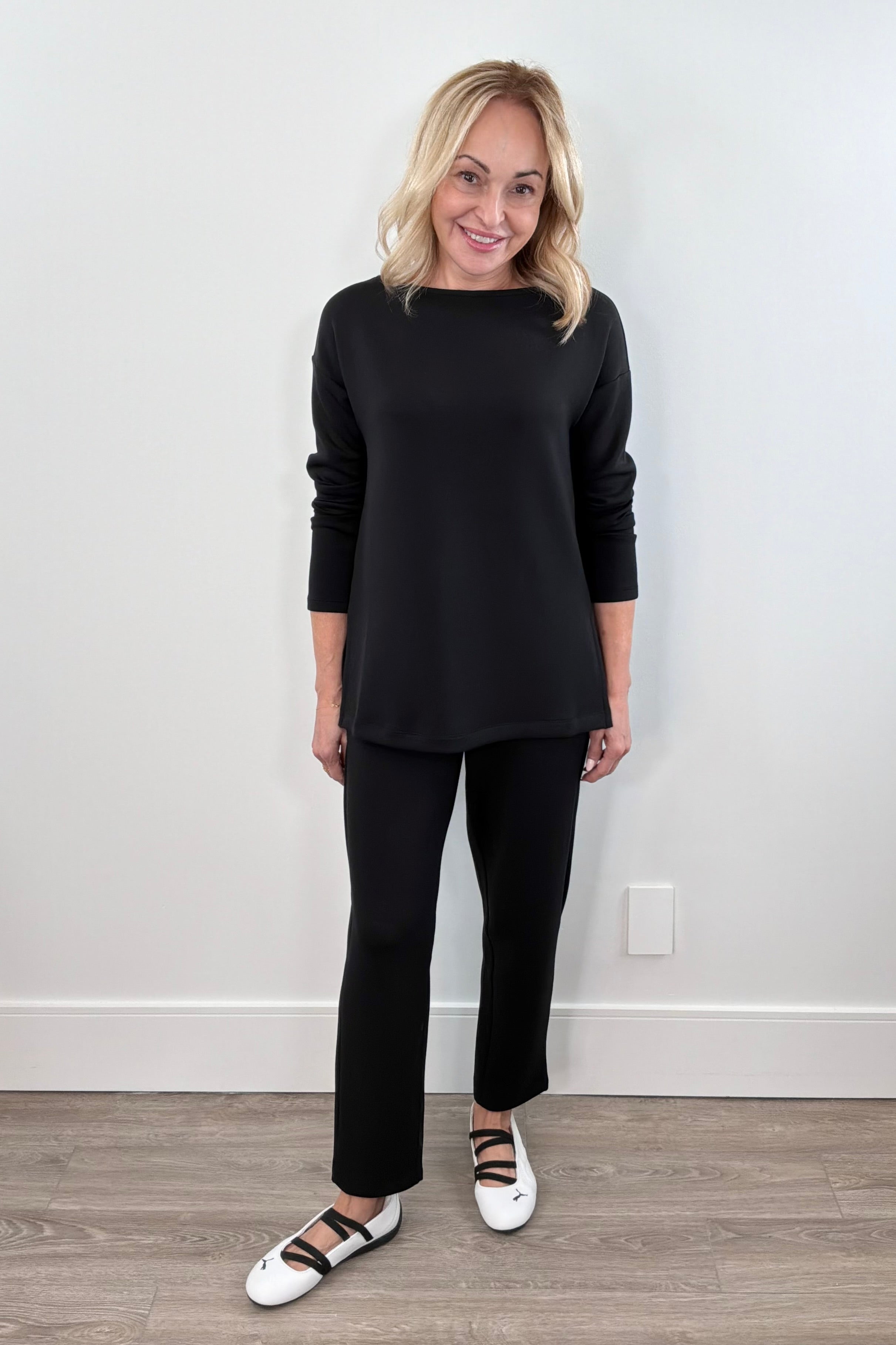 Woman wearing a black tapered straight leg fit pant