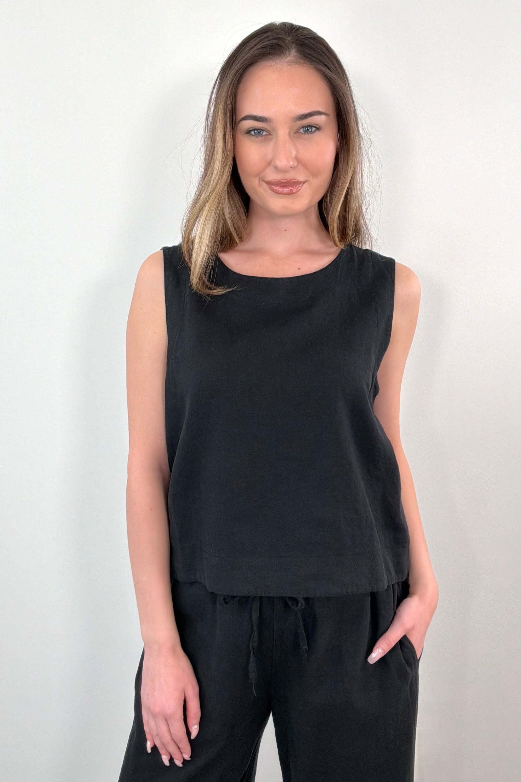 Woman wearing a black linen sleeveless top