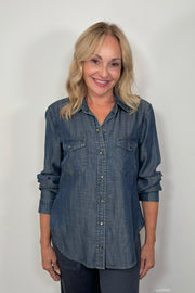 Front view of woman wearing a western snap blue shirt 