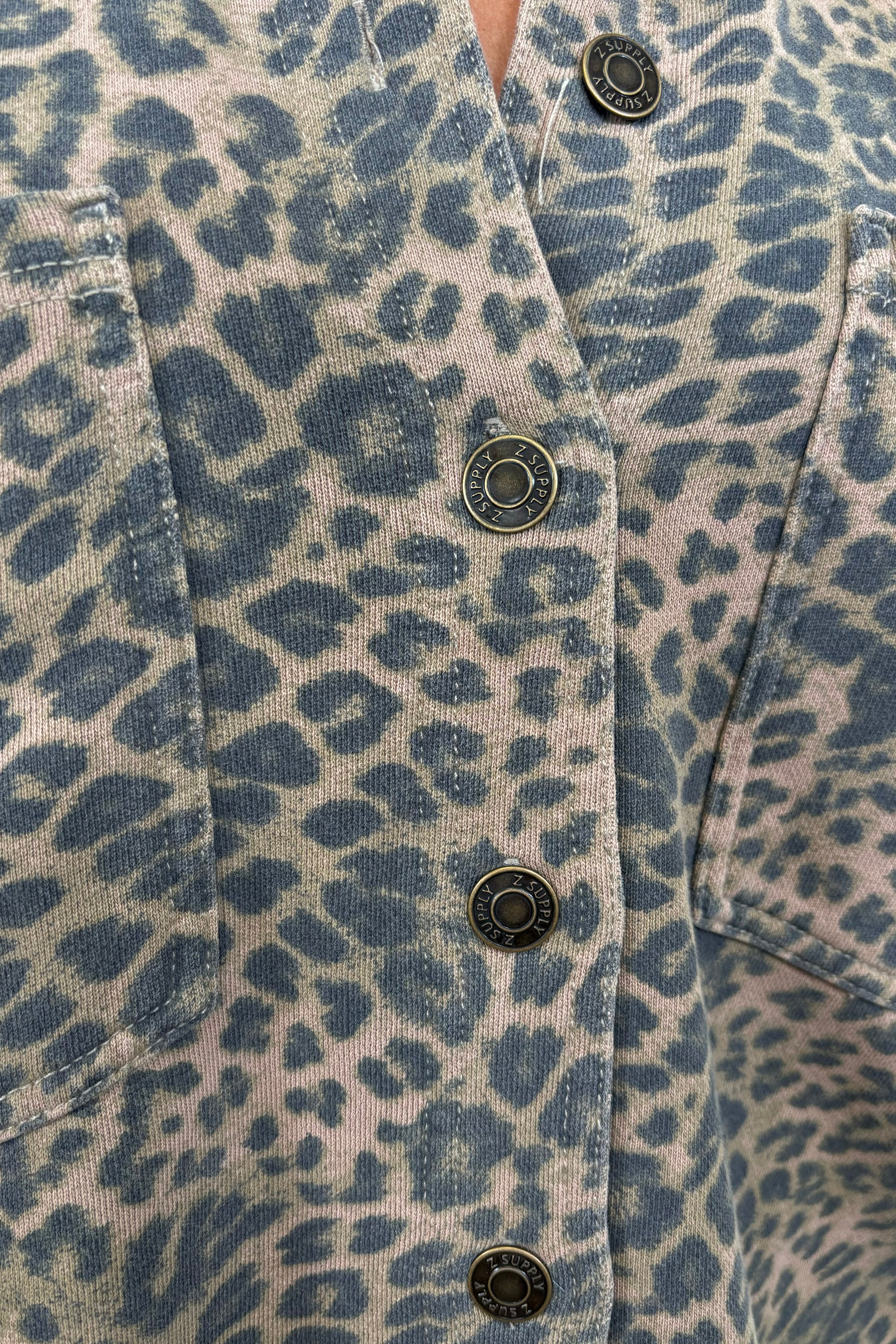 close up of a denim leopard print jacket