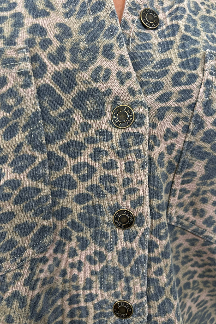 close up of a denim leopard print jacket