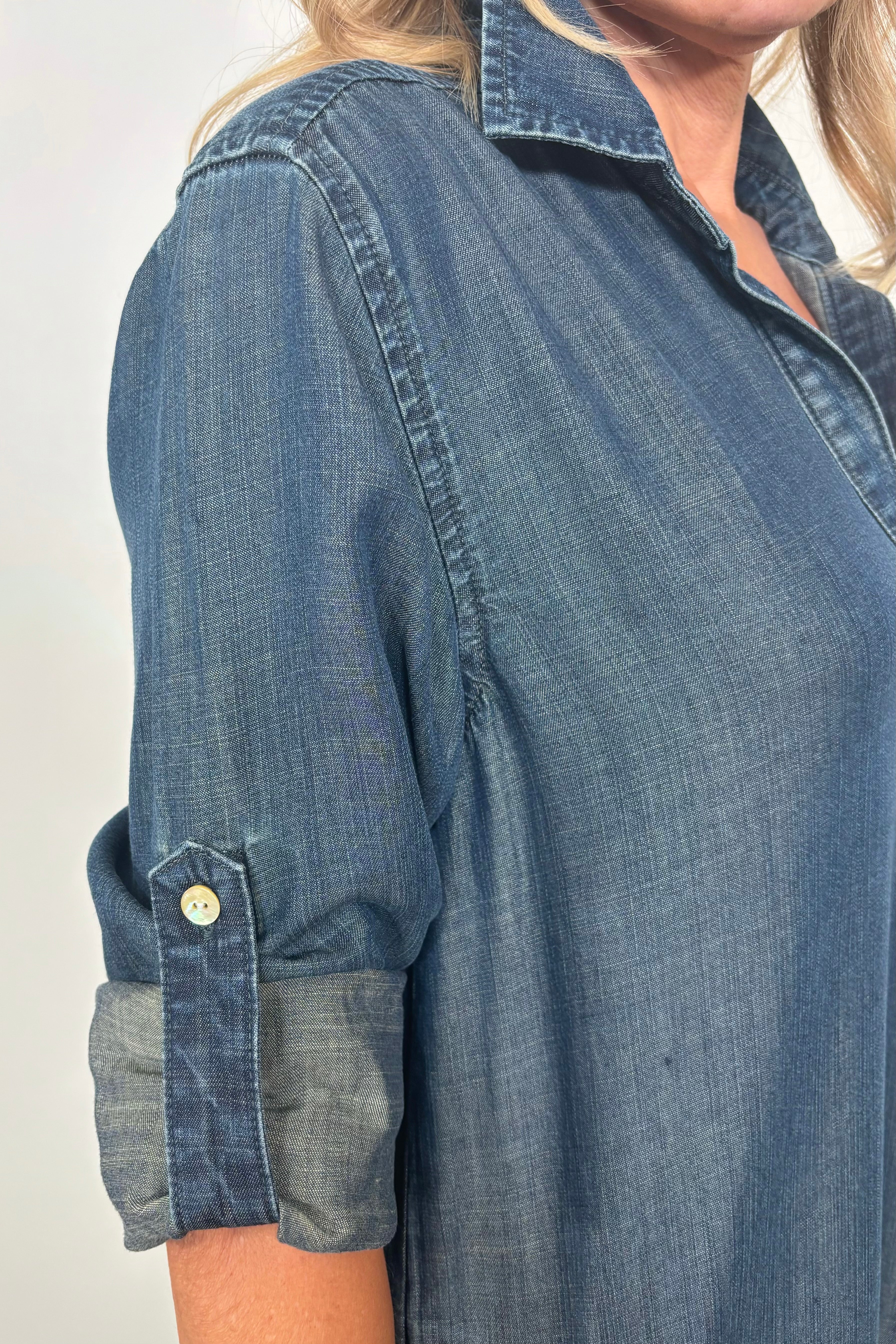 Close up of the collar and sleeve of a blue tencel yoke midi dress