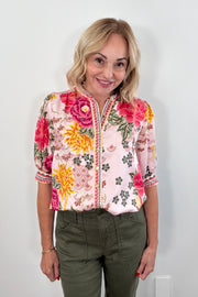 Woman wearing a colorful floral blouse top