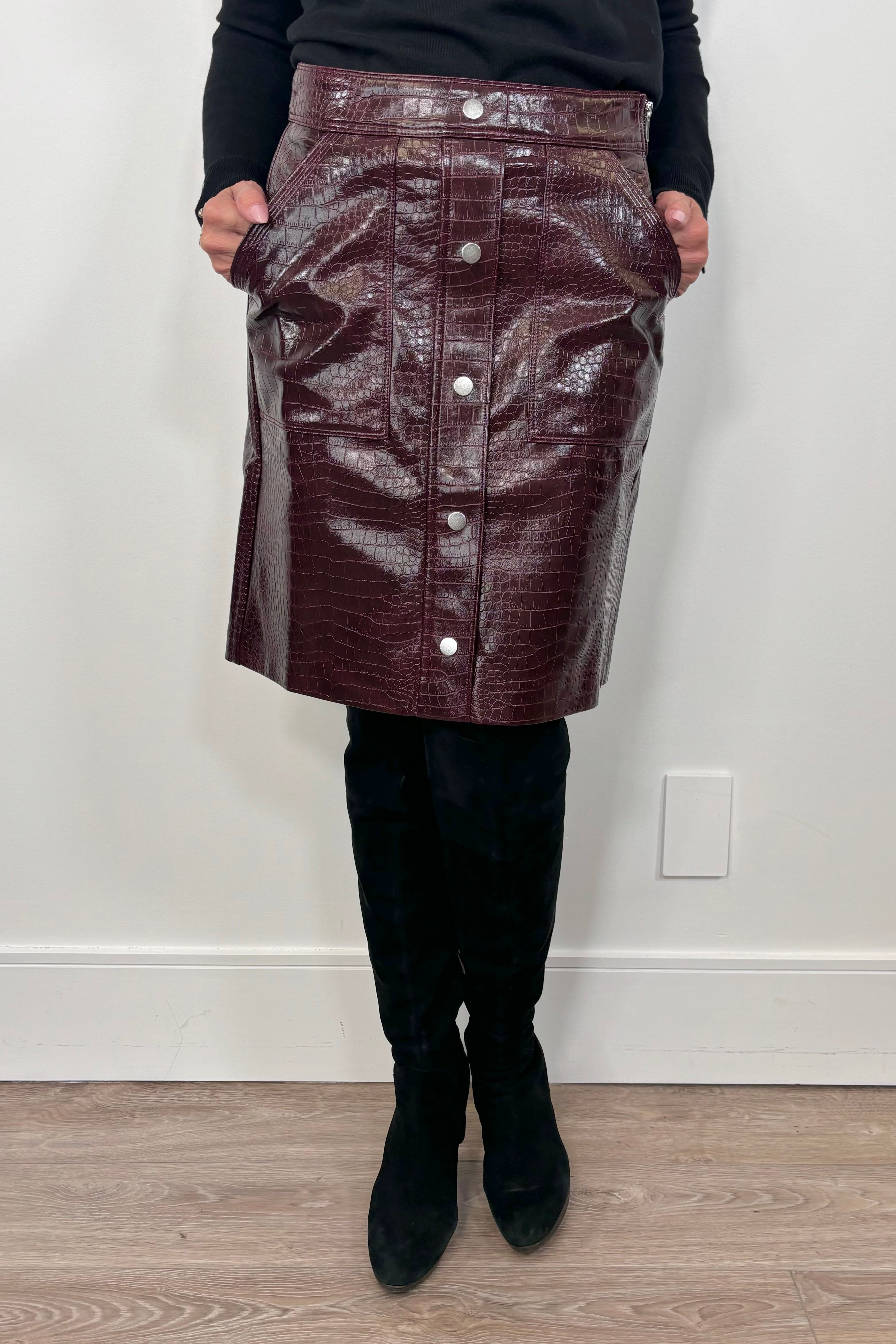 woman wearing a short burgundy button front Russi leather skirt