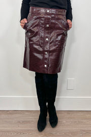 woman wearing a short burgundy button front Russi leather skirt