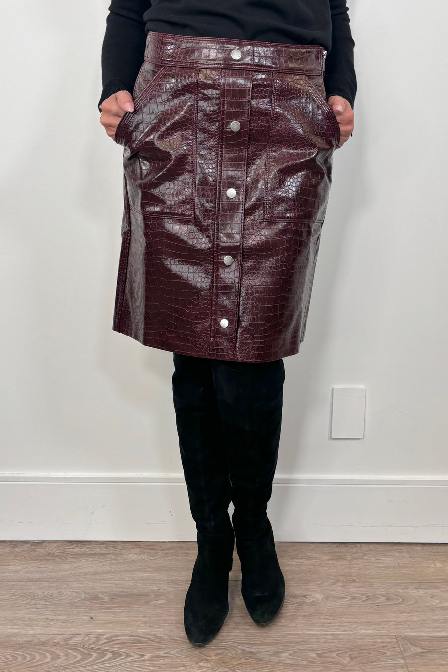 woman wearing a short burgundy button front Russi leather skirt
