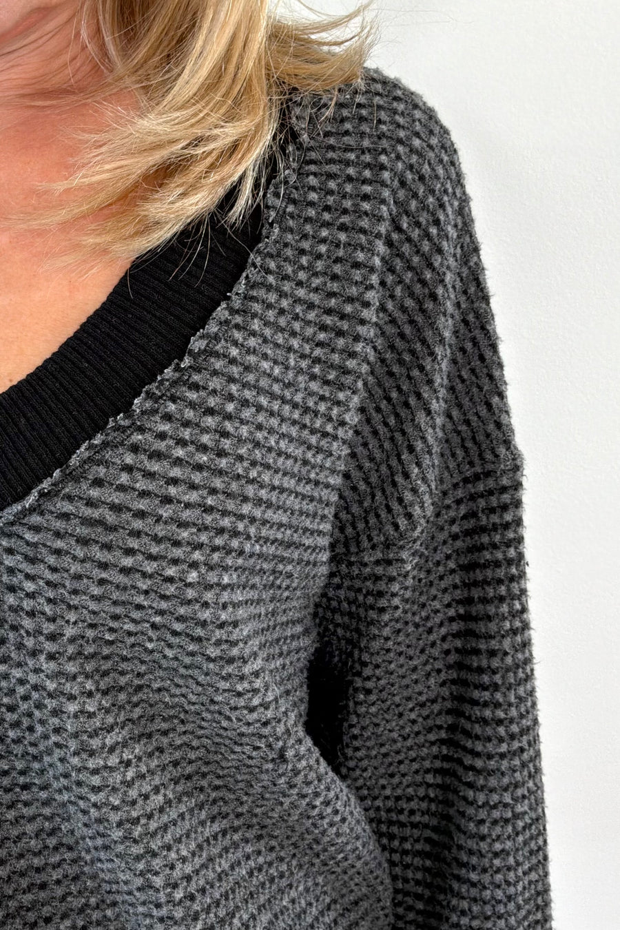 close-up of a black and gray top with black trim 