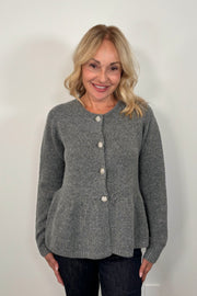 woman wearing a gray  peplum cardigan