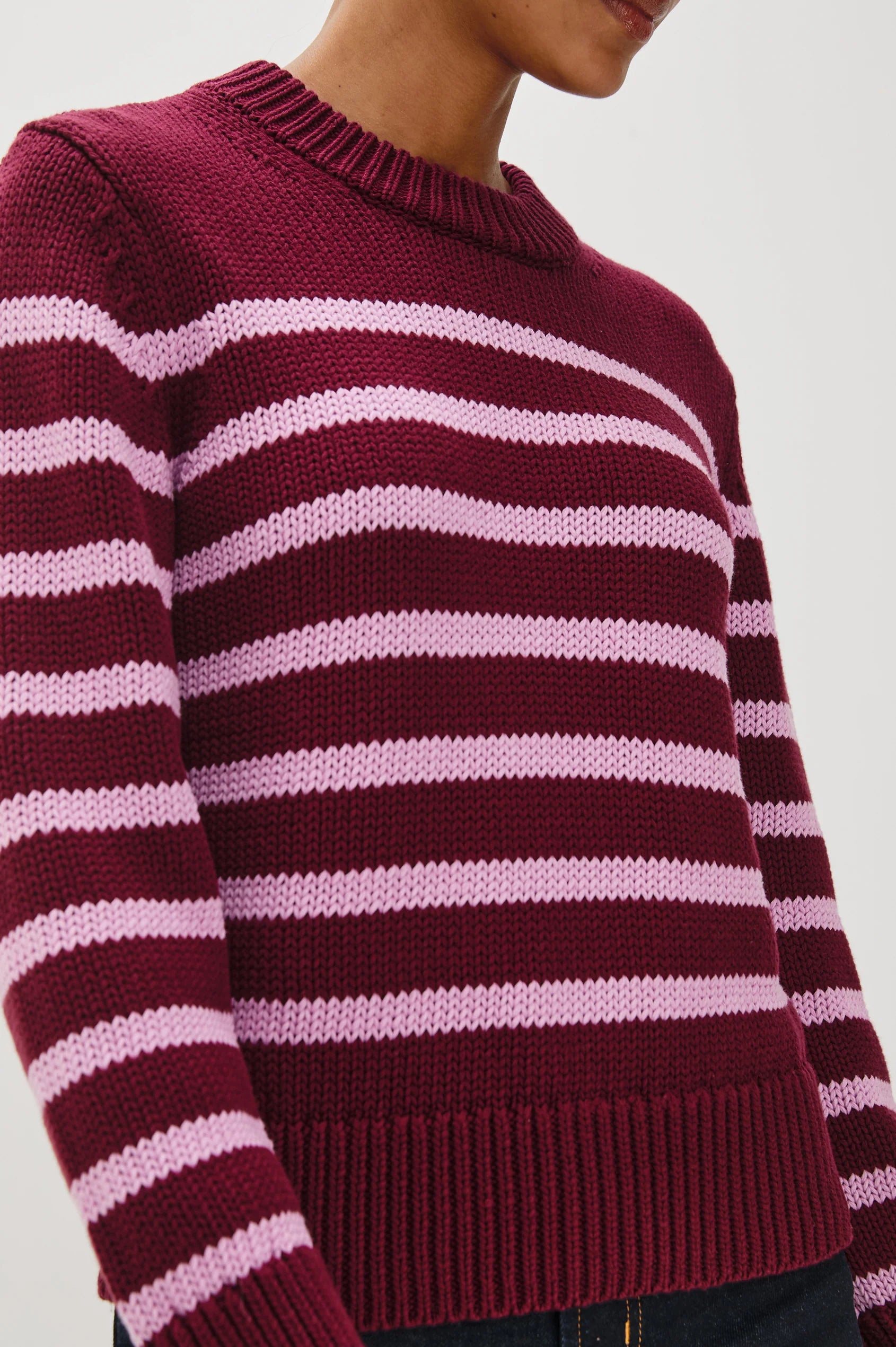 close-up of a maroon and pink striped sweater 