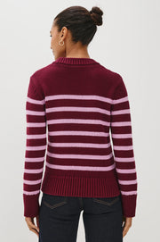Woman wearing a maroon and pink striped sweater 