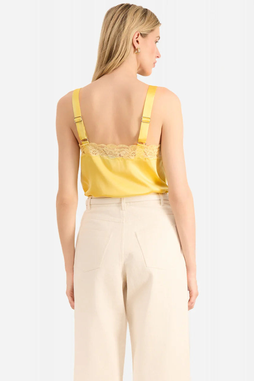 woman wearing a yellow lace-trimmed Cami top