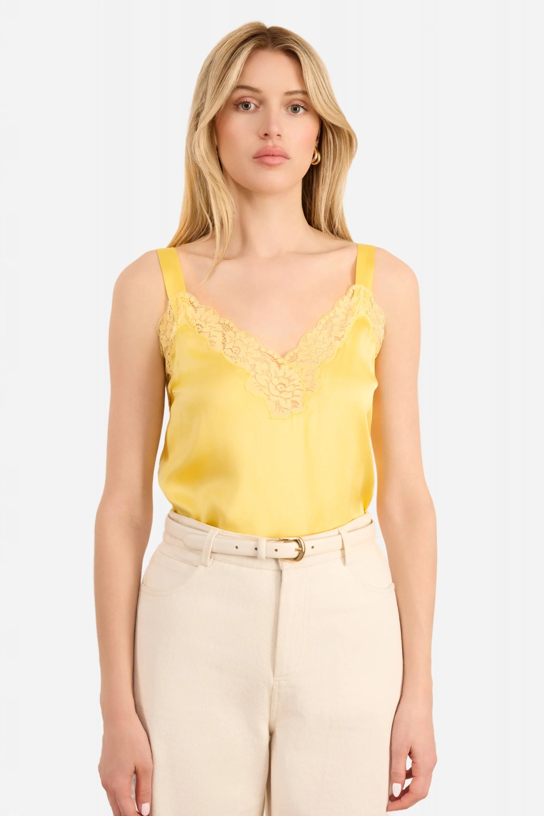 Woman wearing a yellow lace-trimmed Cami top