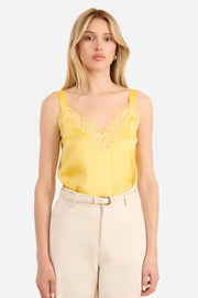 Woman wearing a yellow lace-trimmed Cami top