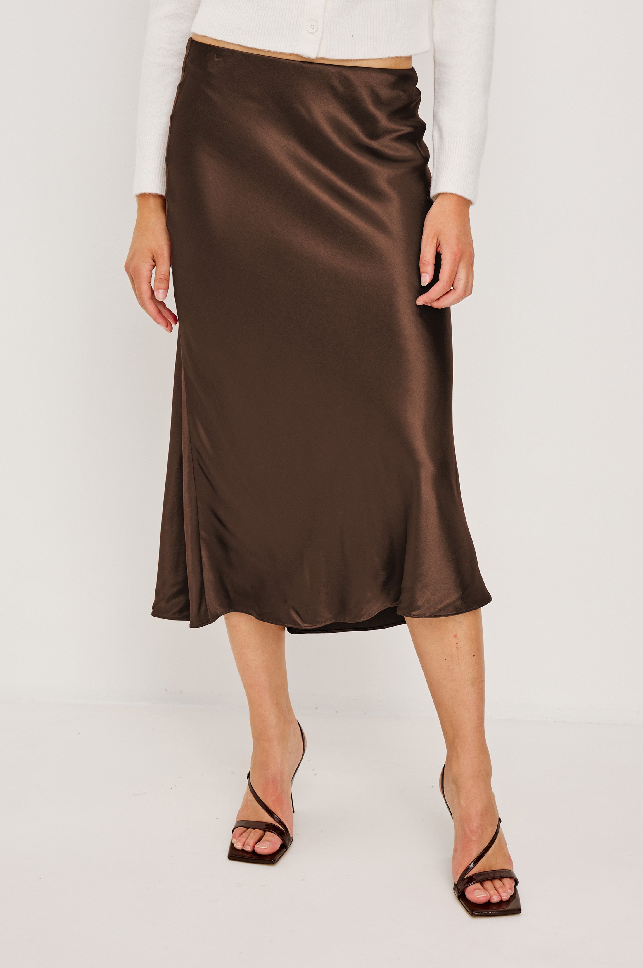 Front view of woman wearing a brown satin skirt