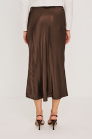 back view of woman wearing a brown satin skirt