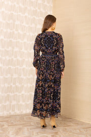 Back view of woman wearing a black v-neck maxi dress with a colourful pattern