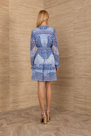 Woman wearing a blue patterned long sleeve short dress