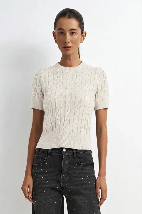 woman wearing a cream short sleeve sweater 