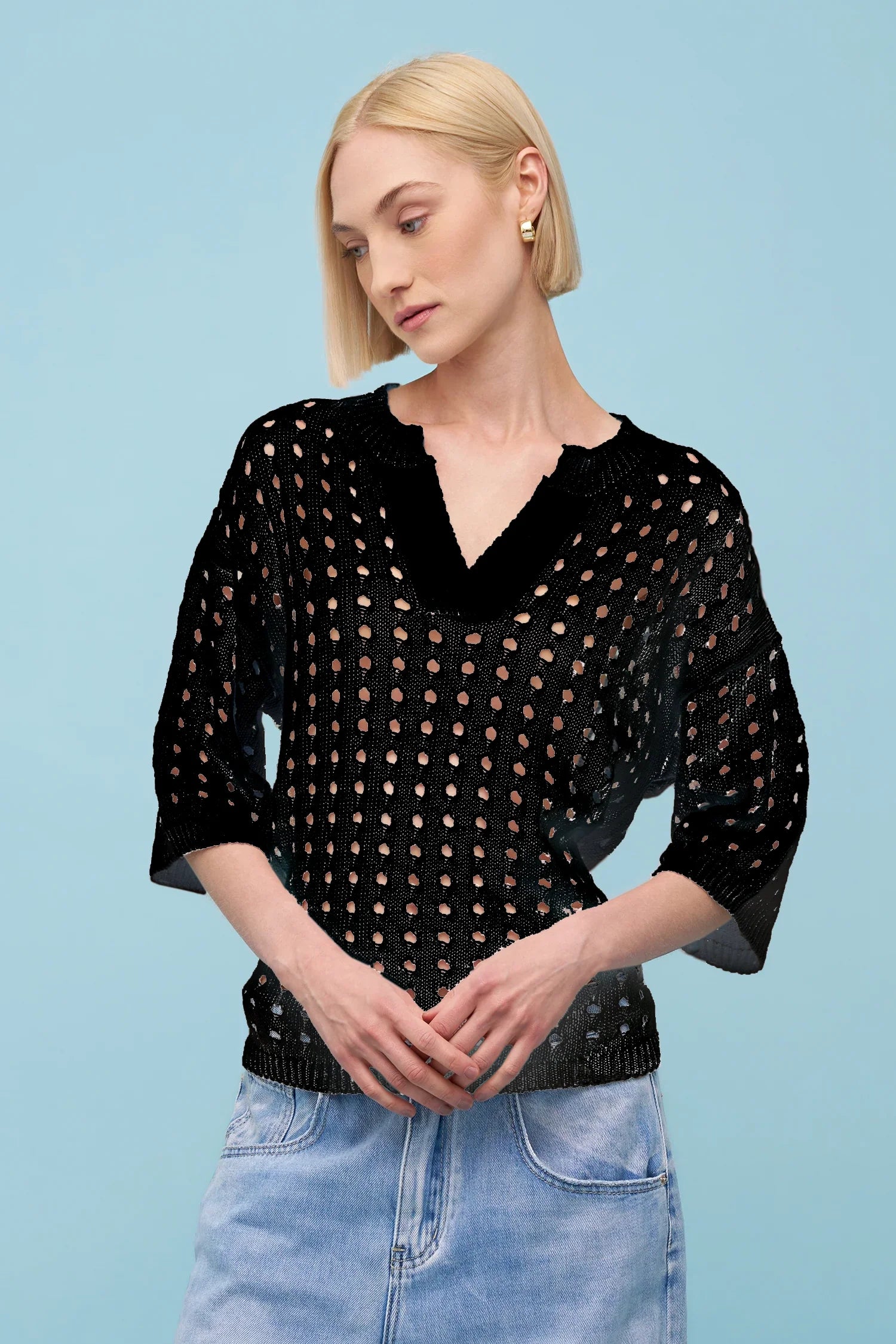 woman wearing a black open knit 3/4 sleeve top