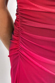 Close-up of a colourful red dress with ruched detailing