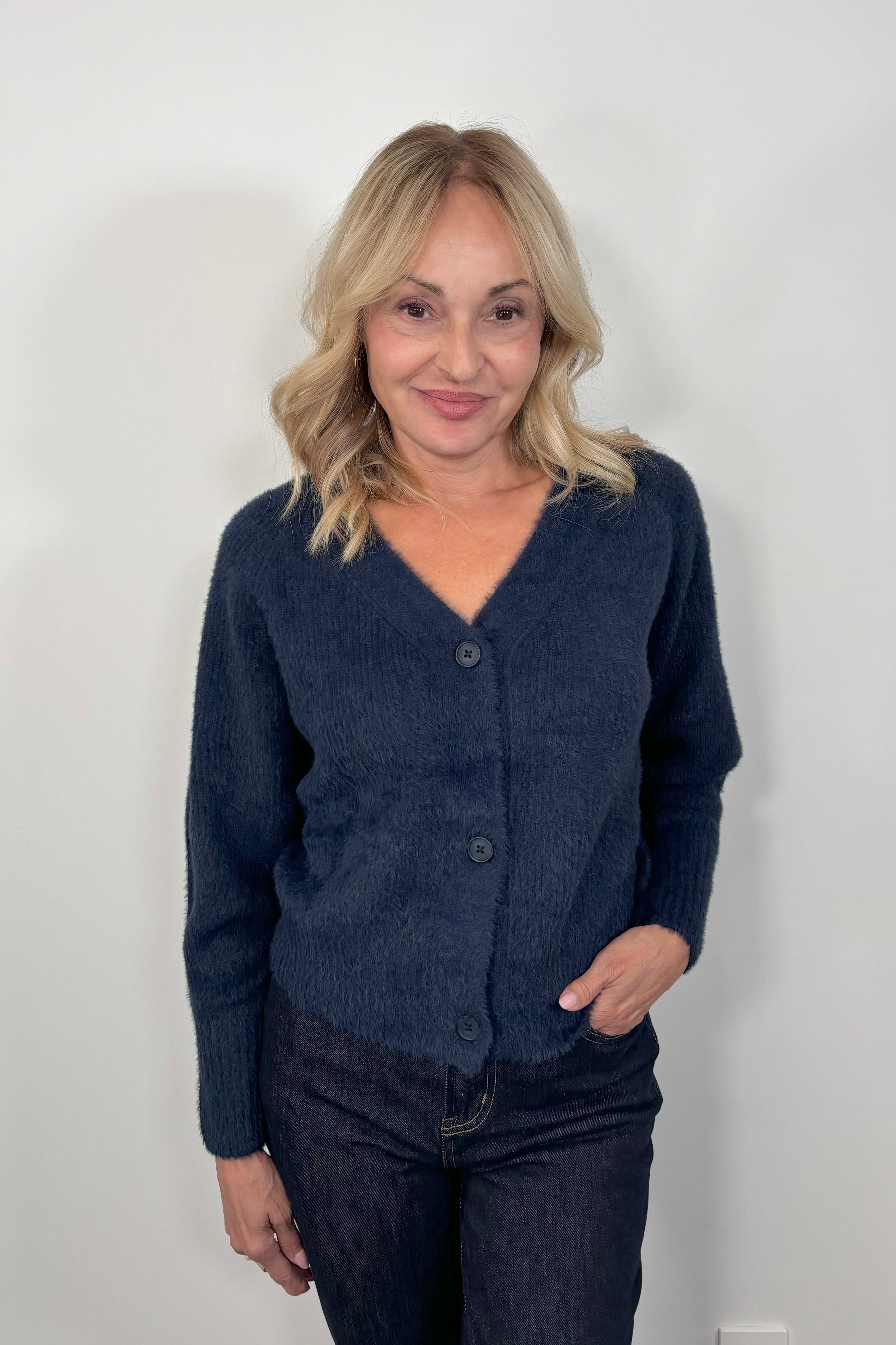 woman wearing a blue pocketless cardigan