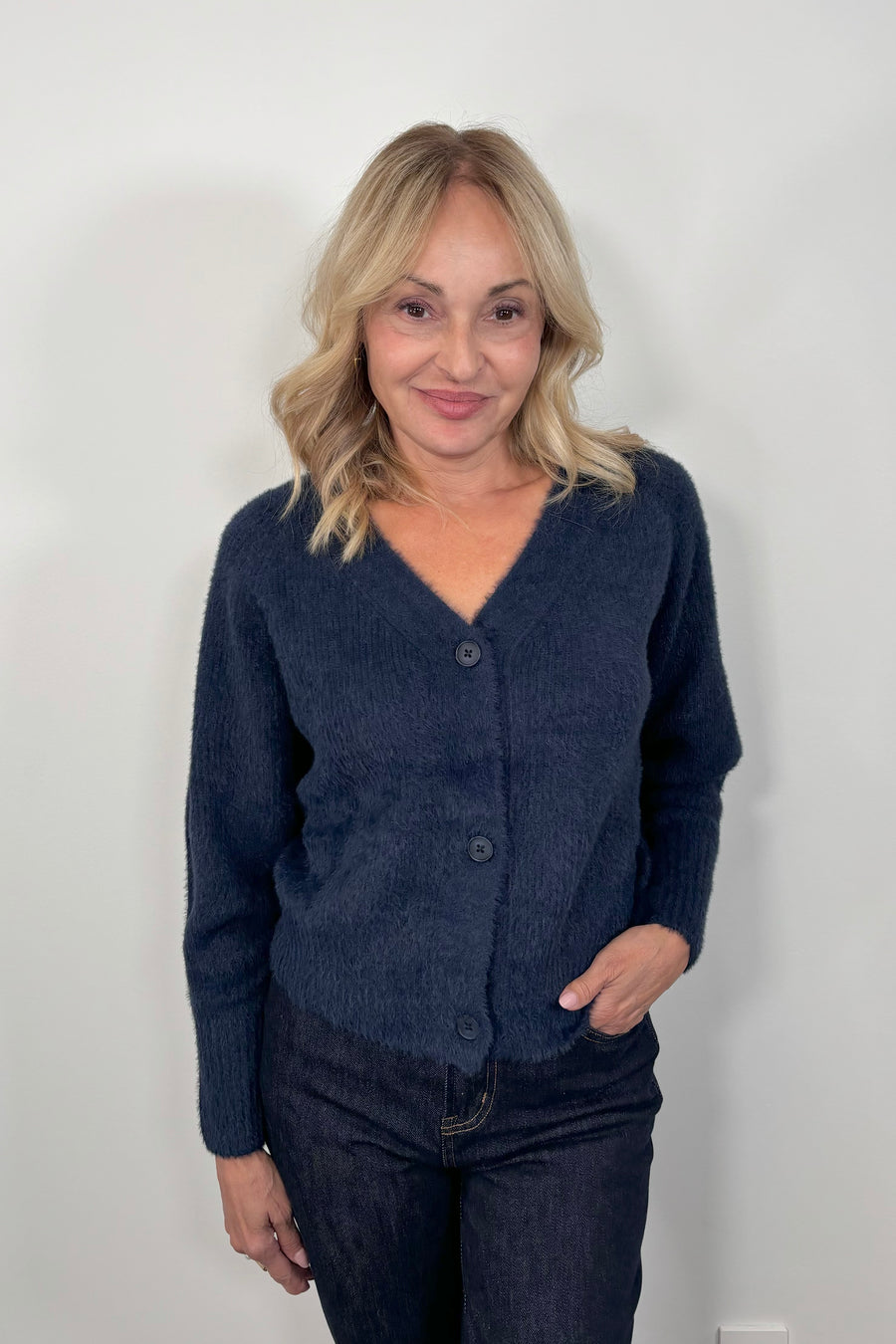 woman wearing a blue pocketless cardigan