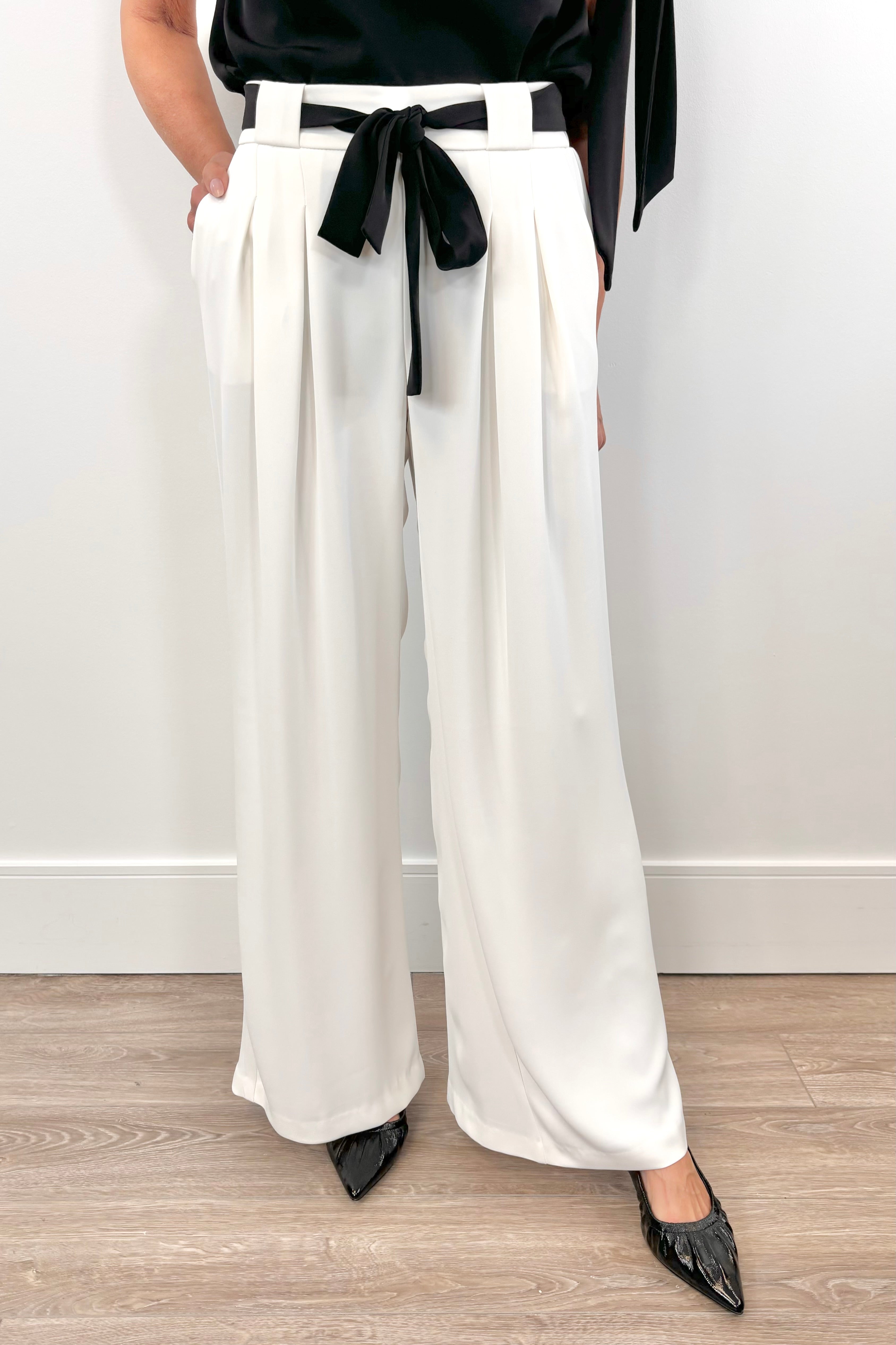 woman wearing a white pant with white shash belt 